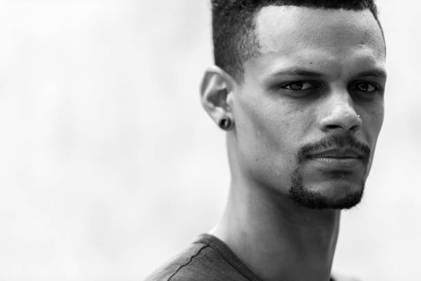 istock Face of young handsome African man against concrete wall 665280608