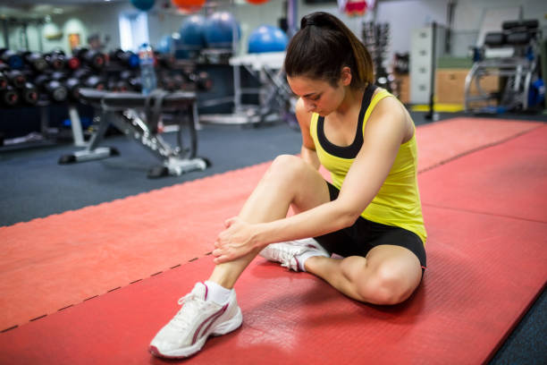 istock Woman massaging her injured leg 665287588