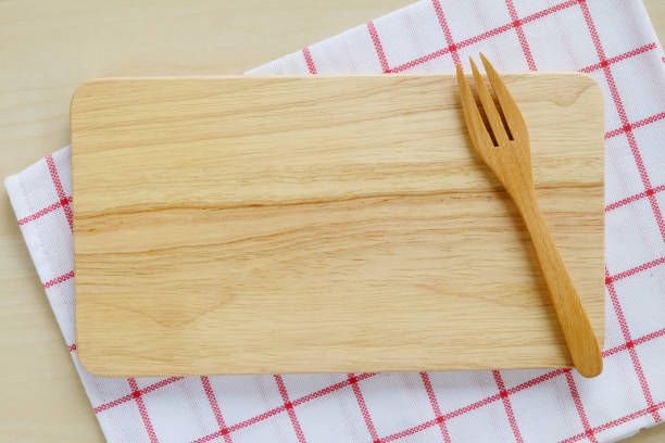istock Empty wooden tray and fork on table, food background, flat lay 665291152