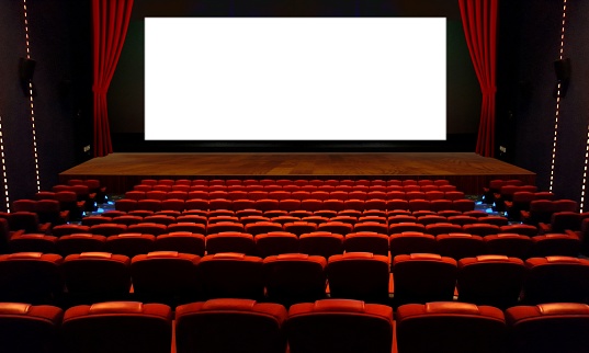 Empty cinema hall with red seats and big wide screen