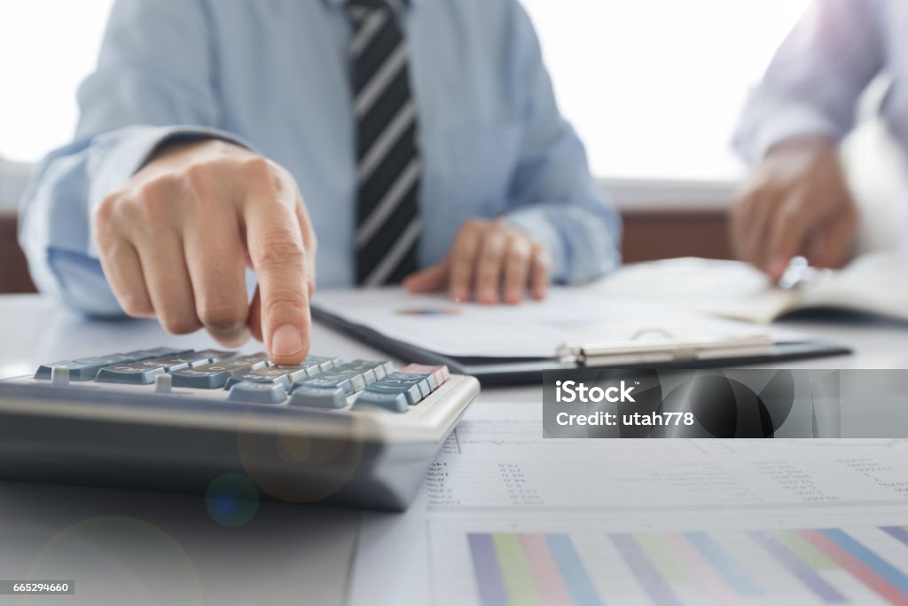 accounting Businessman using a calculator to calculate the numbers. Accounting , Accountancy, Calculation Concept. Accountancy Stock Photo