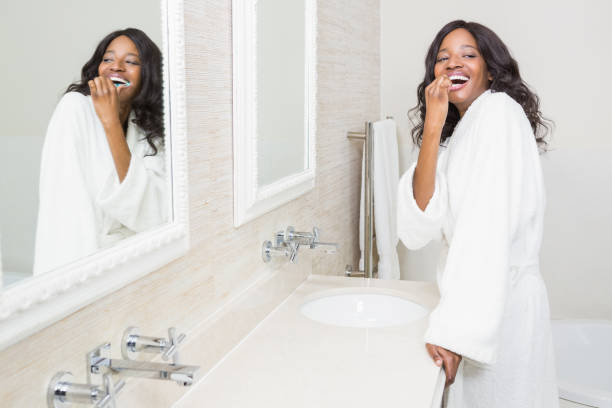 istock Young woman brushing her teeth 665301332