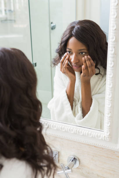 istock Woman checking her skin in bathroom 665304712