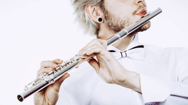 istock Male flutist playing his flute 665304798