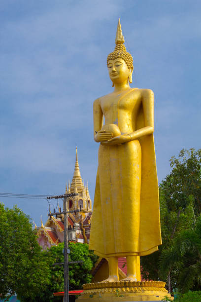 istock Big buddha statue over scenic blue sky background . 665305268