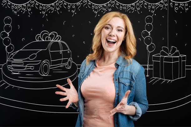 istock Cheerful woman winning the car 665305740