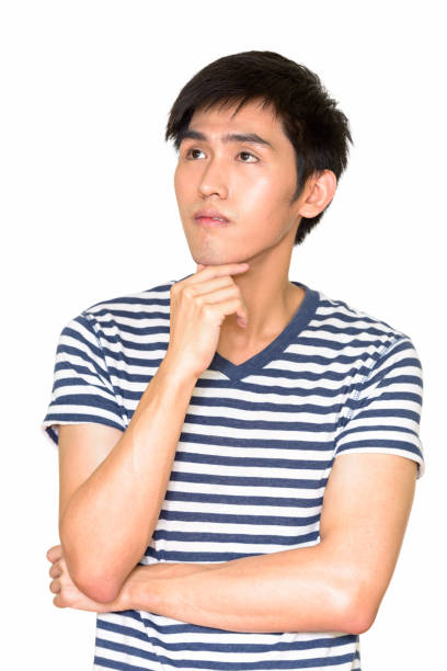 istock Studio shot of young handsome Asian man thinking against white background 665308658