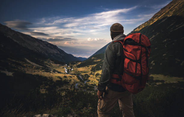 istock Traveler watching the sunset over the mountains 665312214