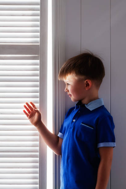 istock Portrait of a boy at a window 665315910
