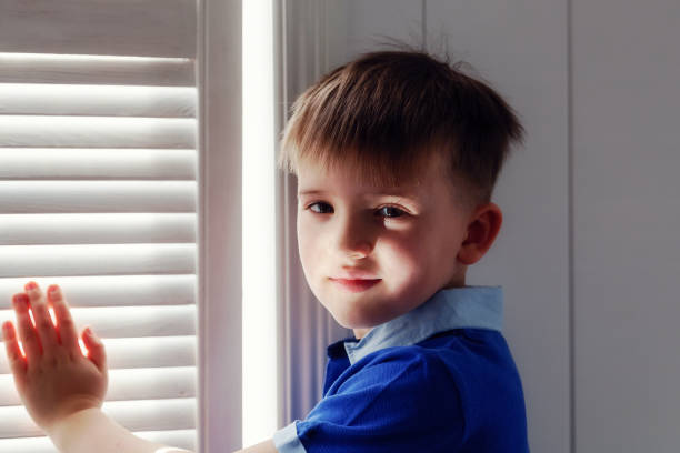 istock Portrait of a boy at a window 665315958