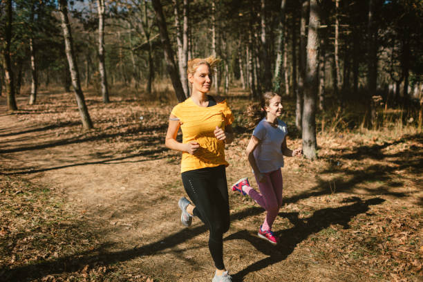 istock Mother and daughter jogging outdoors 665322584