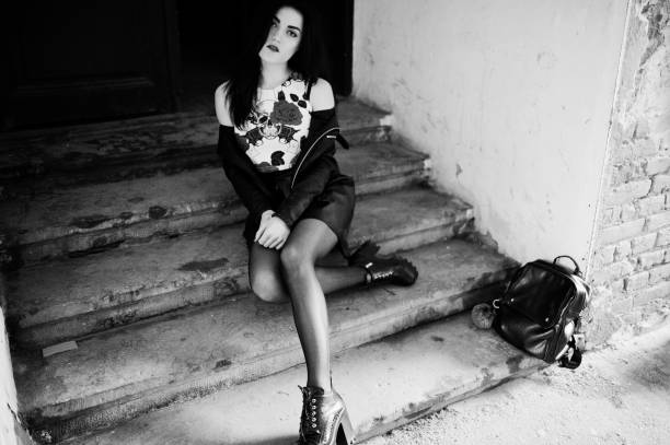 istock Young goth girl on black leather skirt 665322960