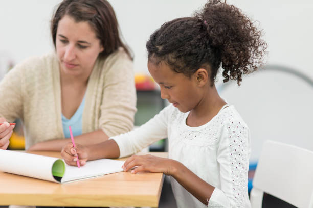 istock Occupational therapist working with children in modern, playful clinic setting 665326984