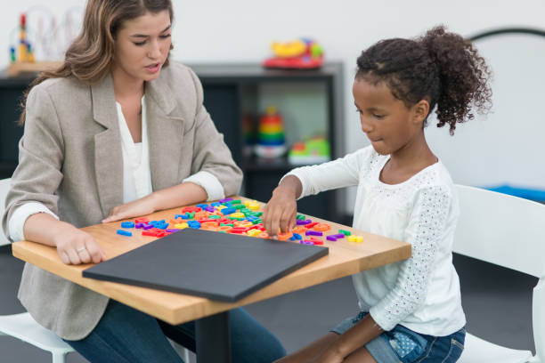istock Occupational therapist working with children in modern, playful clinic setting 665327006