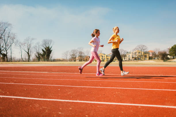 istock Mother and daughter jogging 665329238