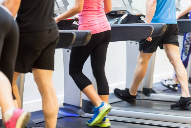 istock Fit people walking on treadmills 665329444