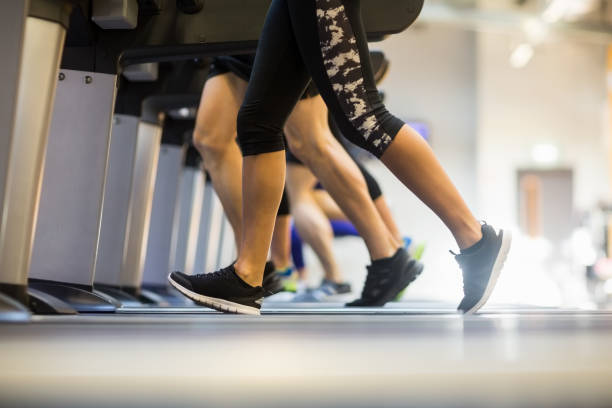 istock Fit people jogging on treadmills 665329952