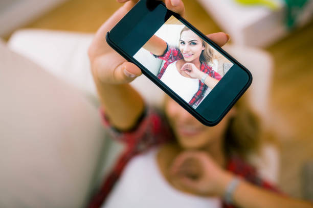 istock Pretty blonde taking a selfie 665330216