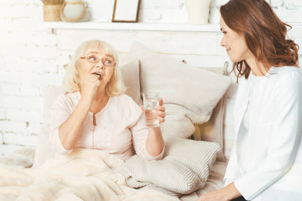 istock Responsible nurse caring about retired pensioner at home 665330816