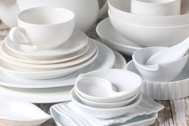 istock Collection of White dishes on wooden table 665333350