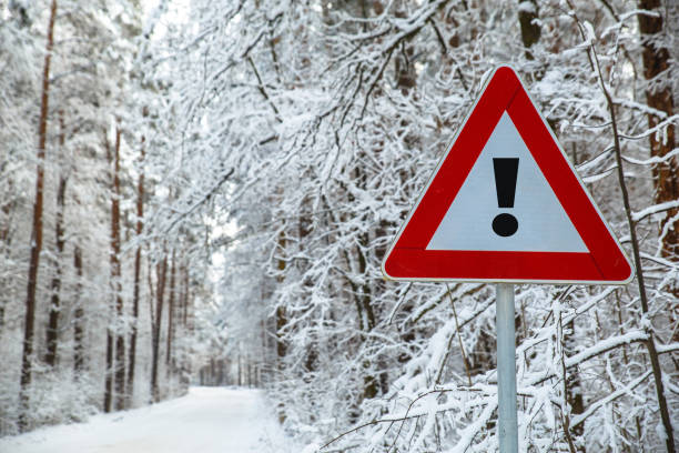 istock Snowy winter road. Attention sign. 665337066