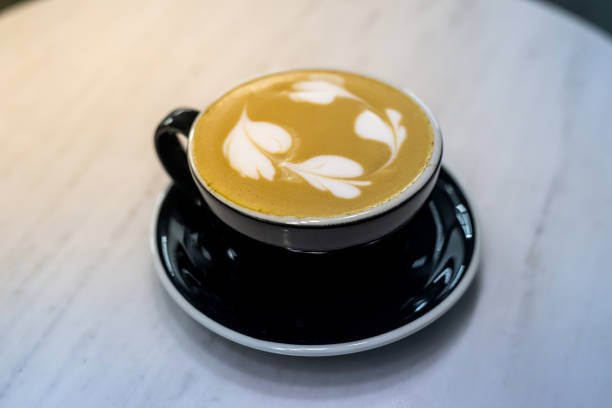 istock hot cup of cappuccino on wooden background 665337742