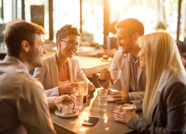 istock Young smiling business people relaxing on coffee break and talking. 665337760