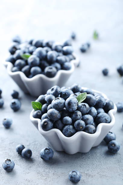 istock Ripe and tasty blueberries on grey wooden table 665344272