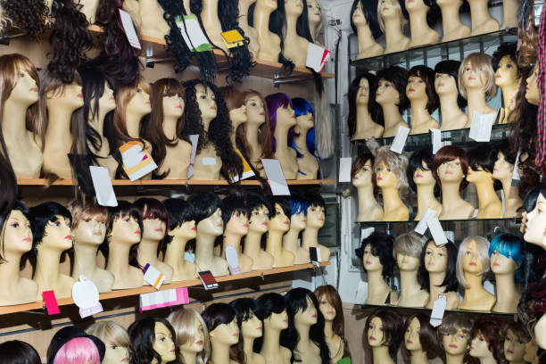 istock Mannequins with blond and brunet style wigs on shelves 665345352