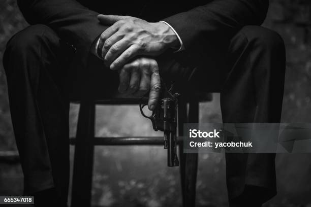Wicked Man Holding His Gun At The Ready Stock Photo - Download Image Now - Mafia, Godfather - Godparent, Villain