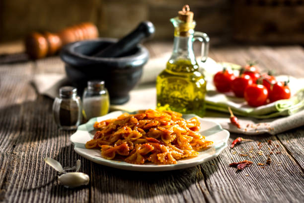 Pasta with tomato sauce on wooden background