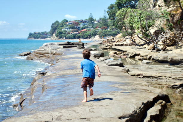 istock A Child Runs on a Concrete Walkway in the Sea 665353456