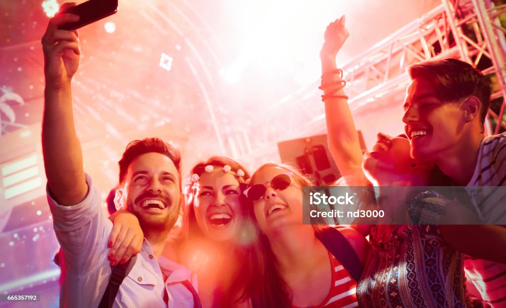 Cheerful friends partying in club at night Party - Social Event Stock Photo