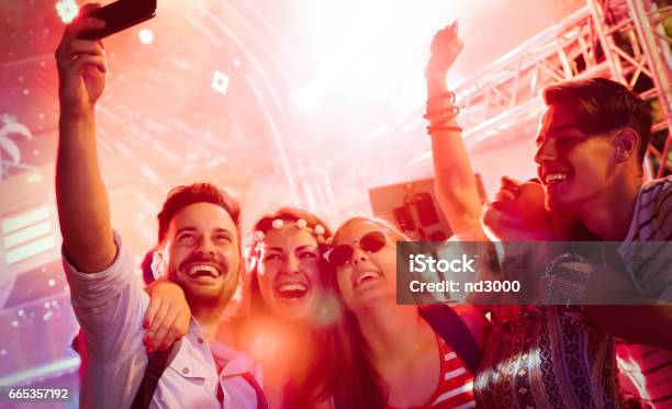 Cheerful Friends Partying In Club At Night Stock Photo - Download Image Now - Party - Social Event, Arts Culture and Entertainment, Fun