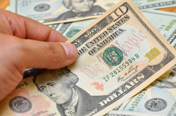 istock Man hand holding ten dollar banknote 665357348