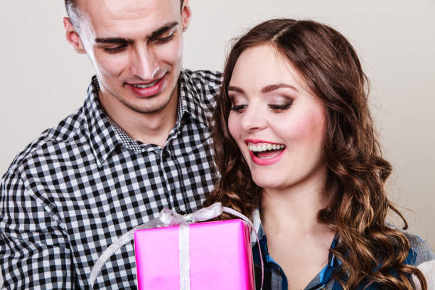 istock happy romantic couple with gift 665361040