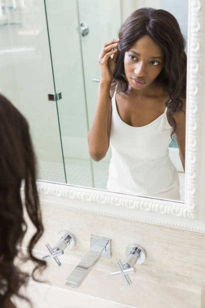 istock Young woman looking her self in mirror 665361698
