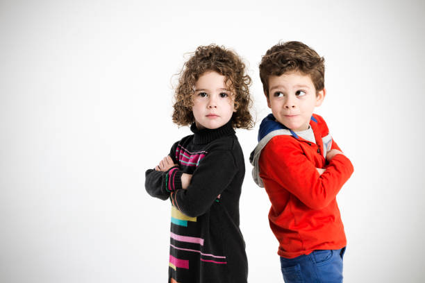 istock boy and girl, portrait in the studio 665364128