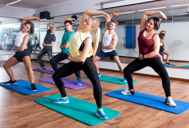 Adults having group fitness class