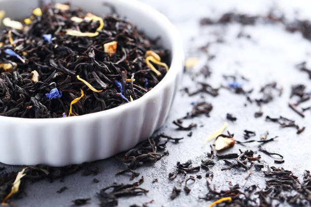 istock Heap of dry tea on grey table 665364922