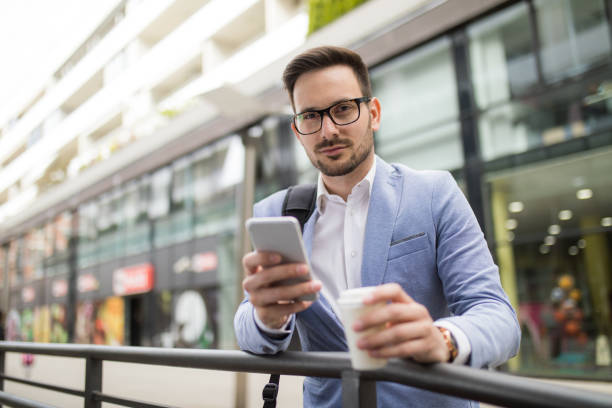 istock Young businessman reading text message on mobile phone. 665366570