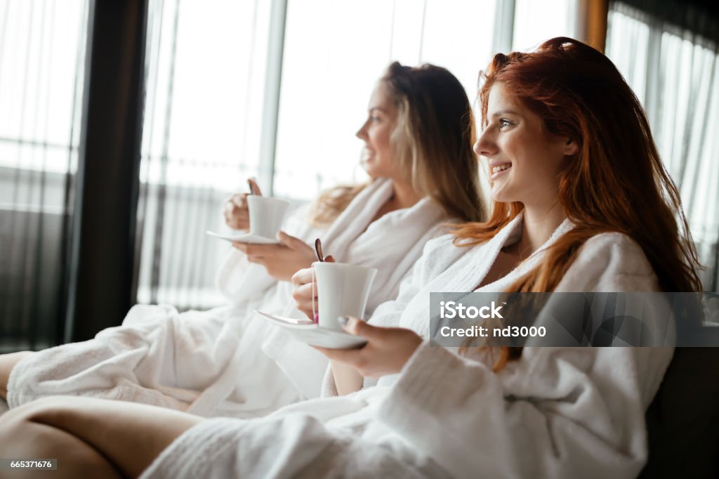 Women in bathrobes enjoying tea and wellness weekend Spa Stock Photo