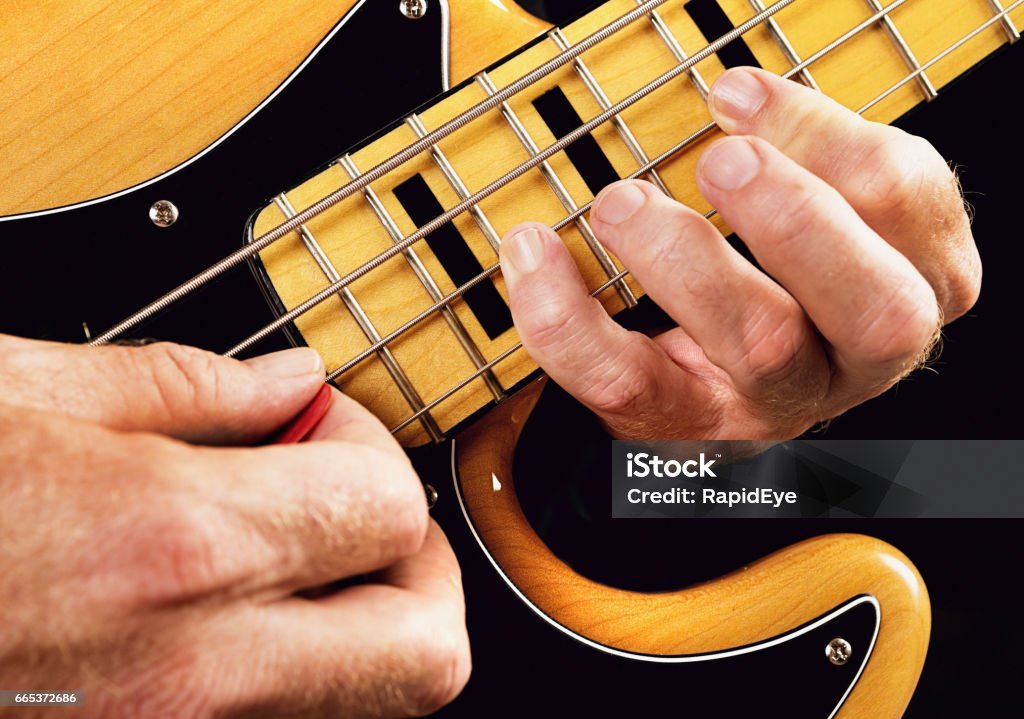 Bass guitar tutorial: hands showing natural minor scale A bass player show the hand positions for playing the natural minor or Aeolian scale on an electric bass guitar. Bass Guitar Stock Photo