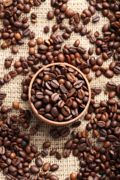 istock Brown roasted coffee beans in bowl on sackcloth 665373118