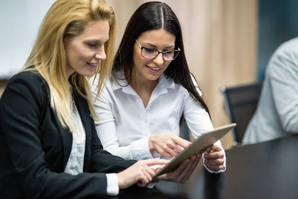 istock Professional business people at meeting collaborating in office 665376954
