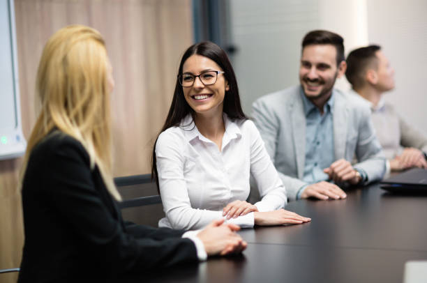 istock Business people sitting at table during board meeting 665377022