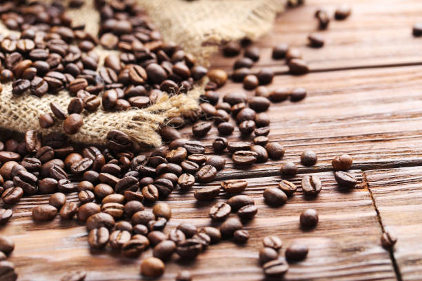 istock Roasted coffee beans on a brown wooden table 665380240