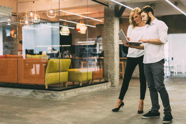 istock Discussing new ideas with a coworker in a beautiful modern office 665381808