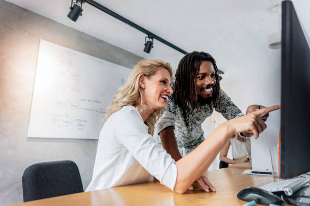 istock Man pointing at screen of desktop and explaining contents 665386286