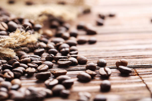 istock Roasted coffee beans on a brown wooden table 665386966